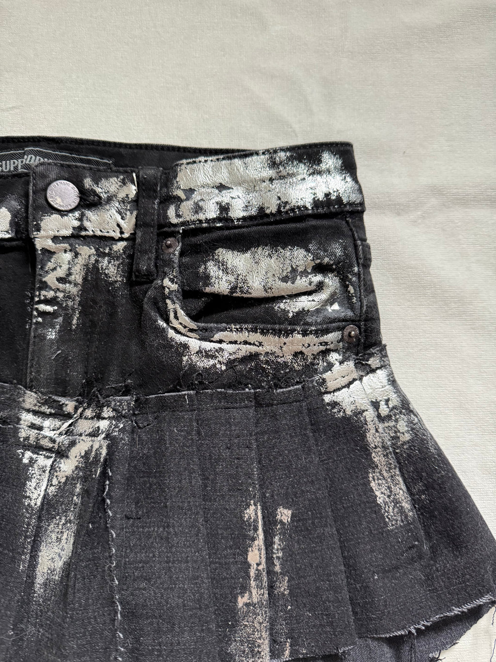 Asymmetrical silver foil pleated mini skirt