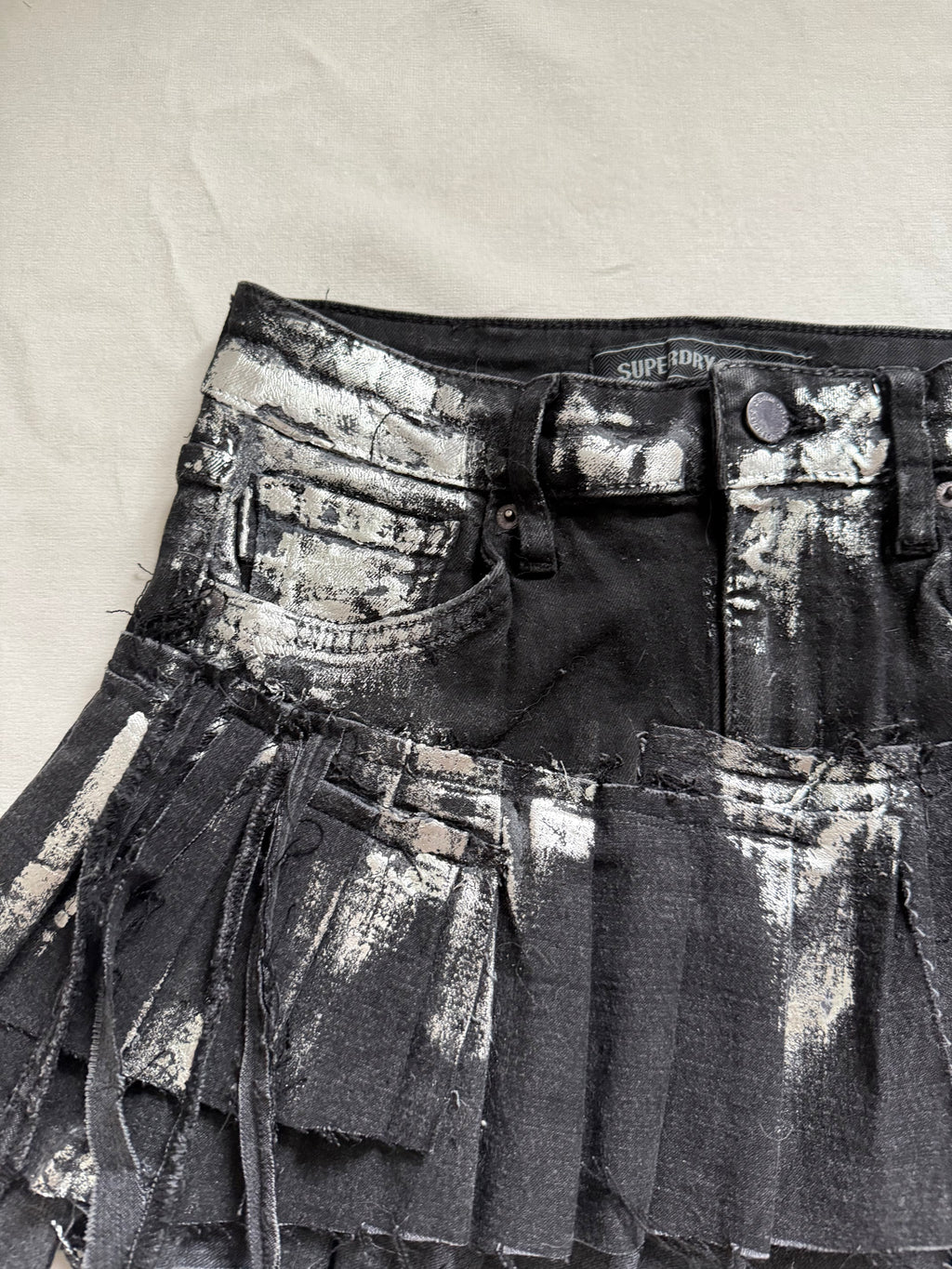 Asymmetrical silver foil pleated mini skirt