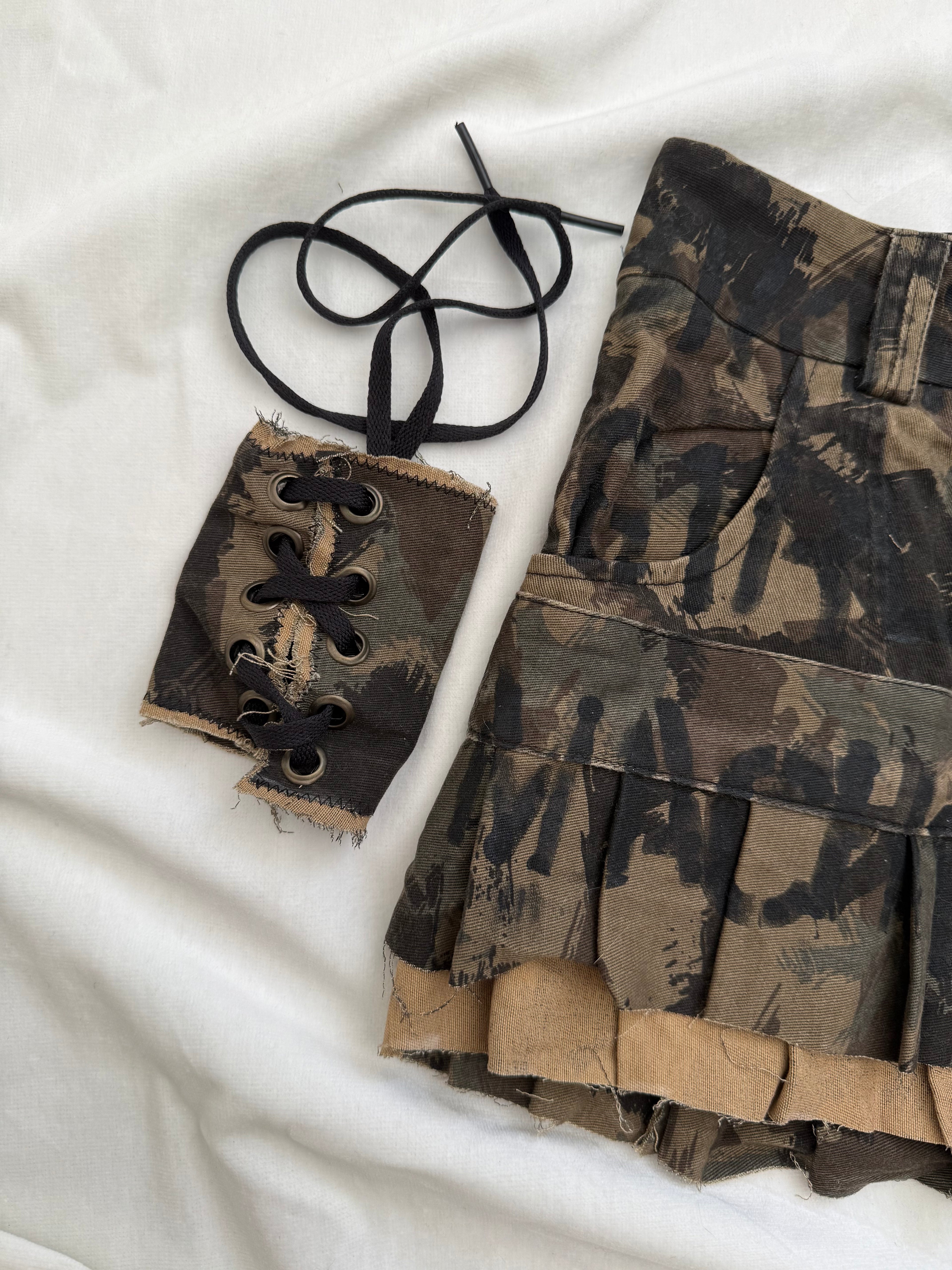 Asymmetrical camo print pleated mini skirt