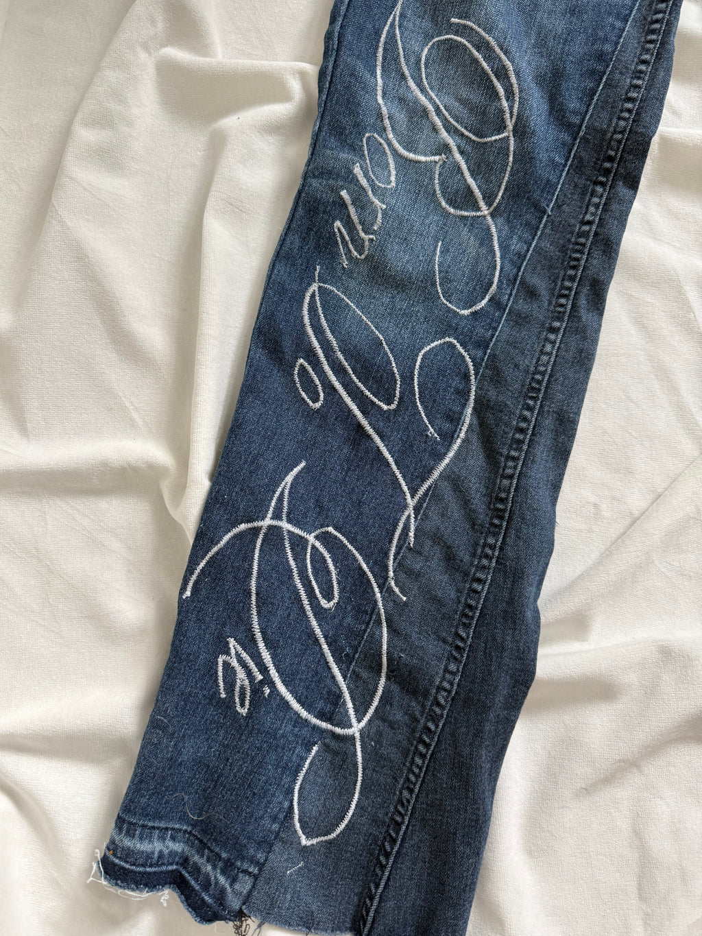 blue denim distressed bootcut jeans